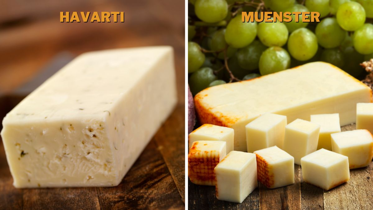 A block of Havarti on a cutting board and half-cubed Muenster on a wooden board served with grapes.